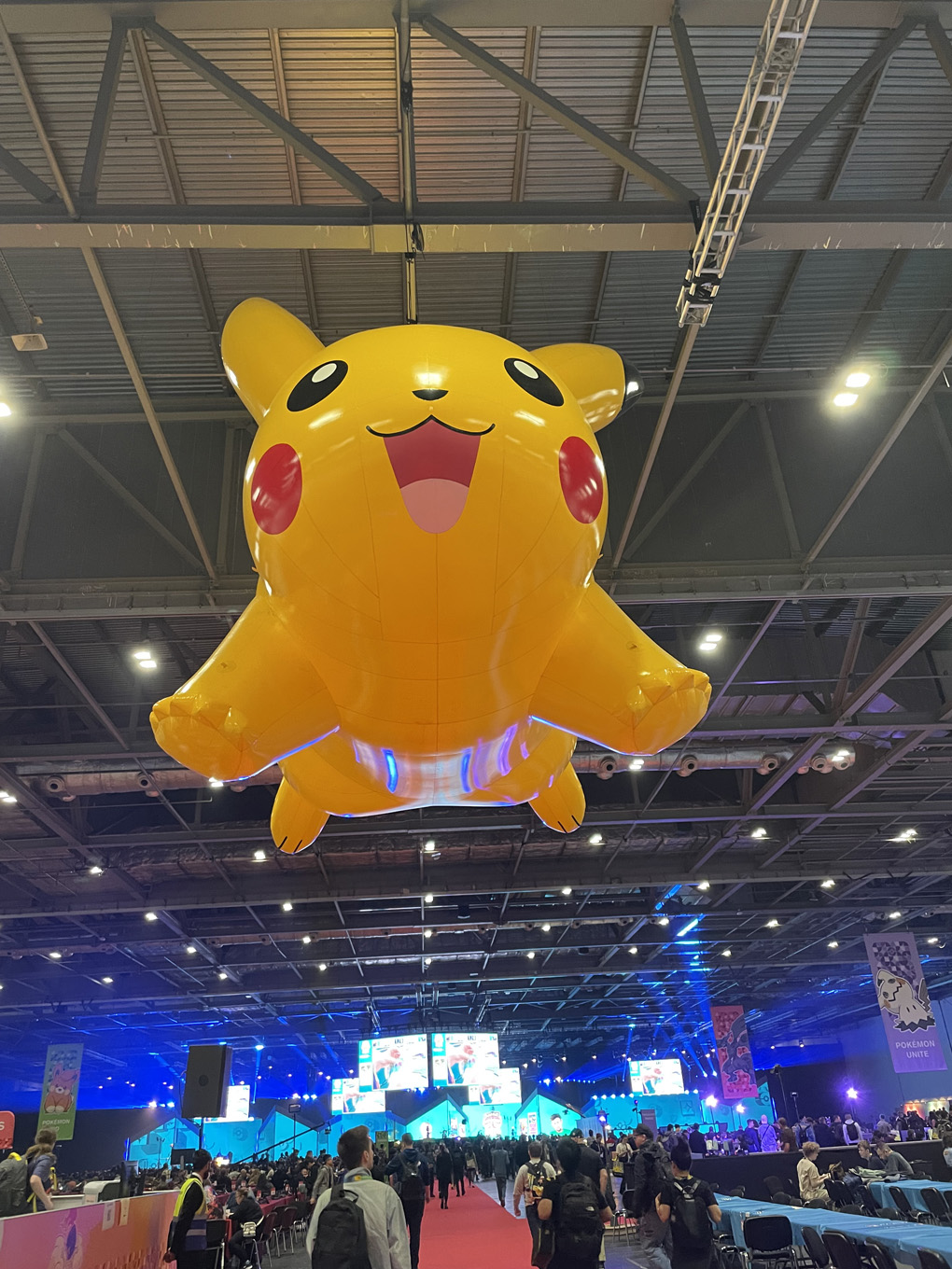 Inflatable giant Pikachu suspended over a conference venue