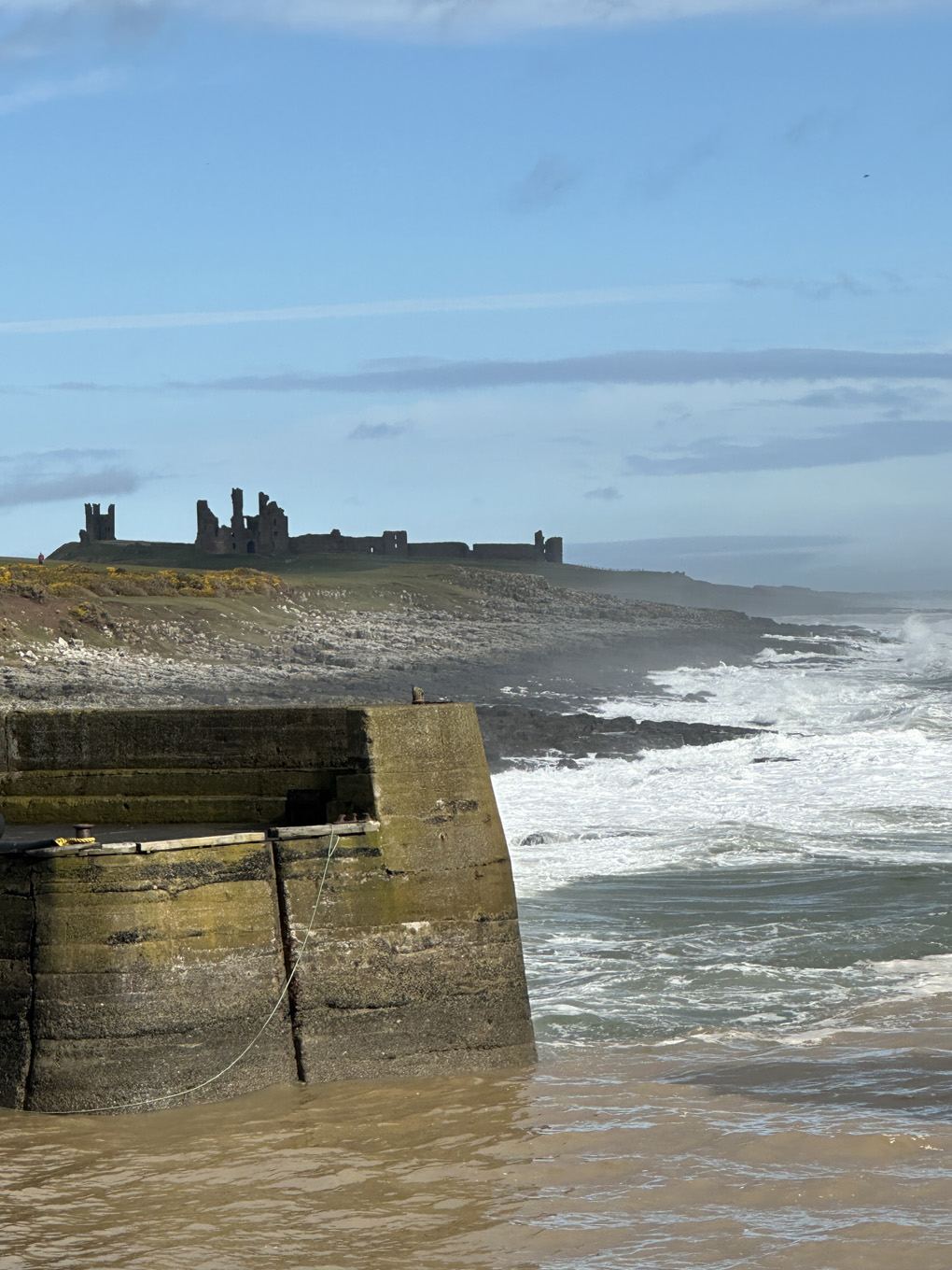 We see a view from Craster to Dunstaburgh Castle, Northumberland coast