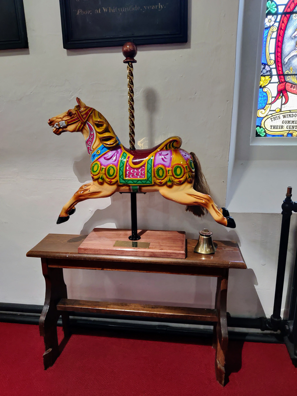 Picture of a wooden fairground horse in a church in Neath.