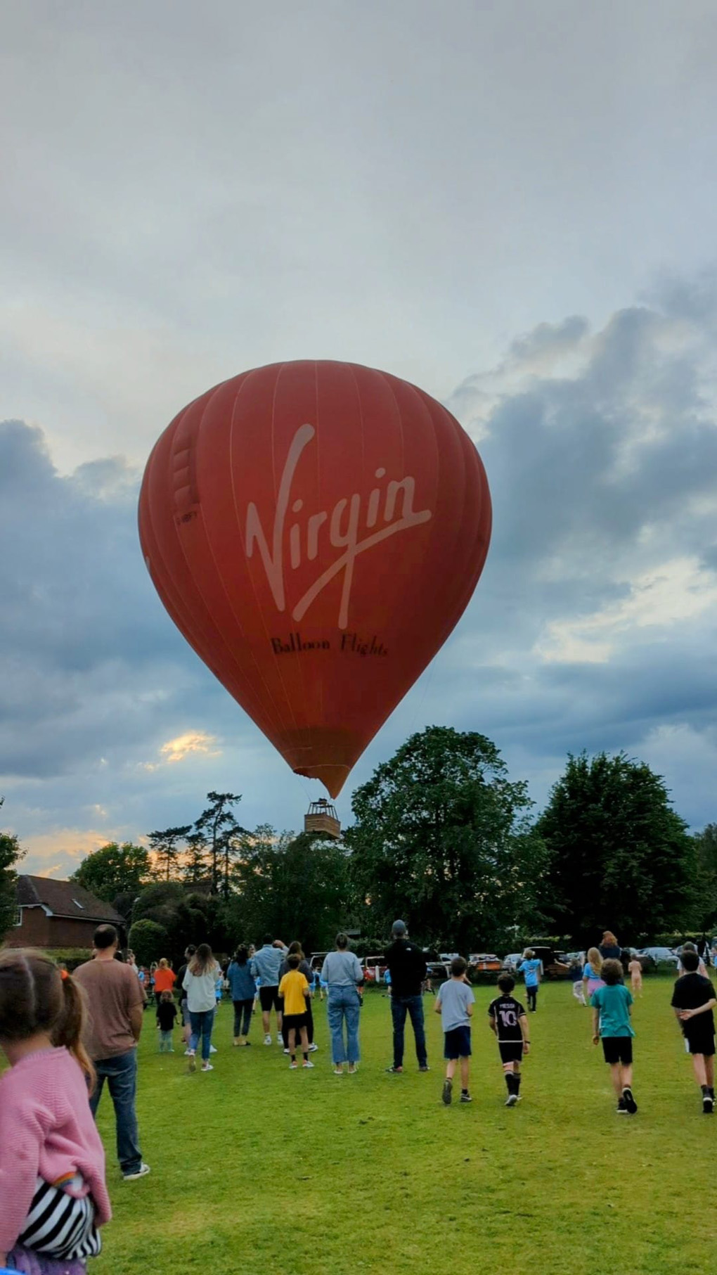 Hot air balloon hitting trees at the edge of a field