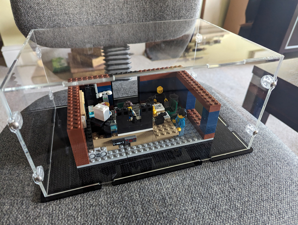 Lego model of a radio station in a clear box.