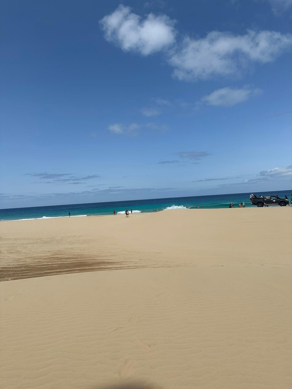 Sandy beach with blue sea and sky