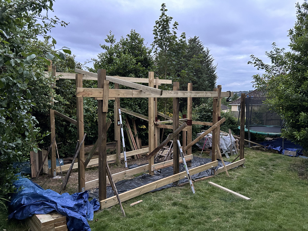 A half-built shed in a garden