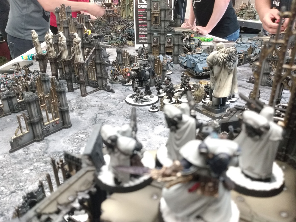 A table of warhammer 40,000 models face off against one another