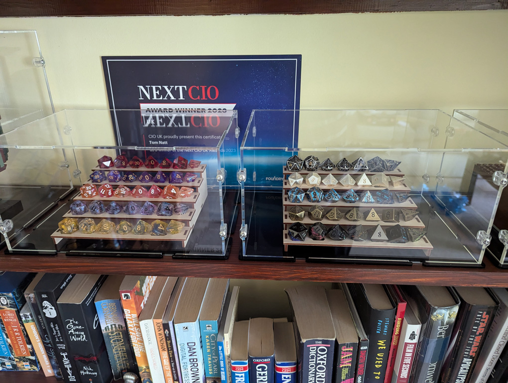 Sets of dice on display stands in a perspex case