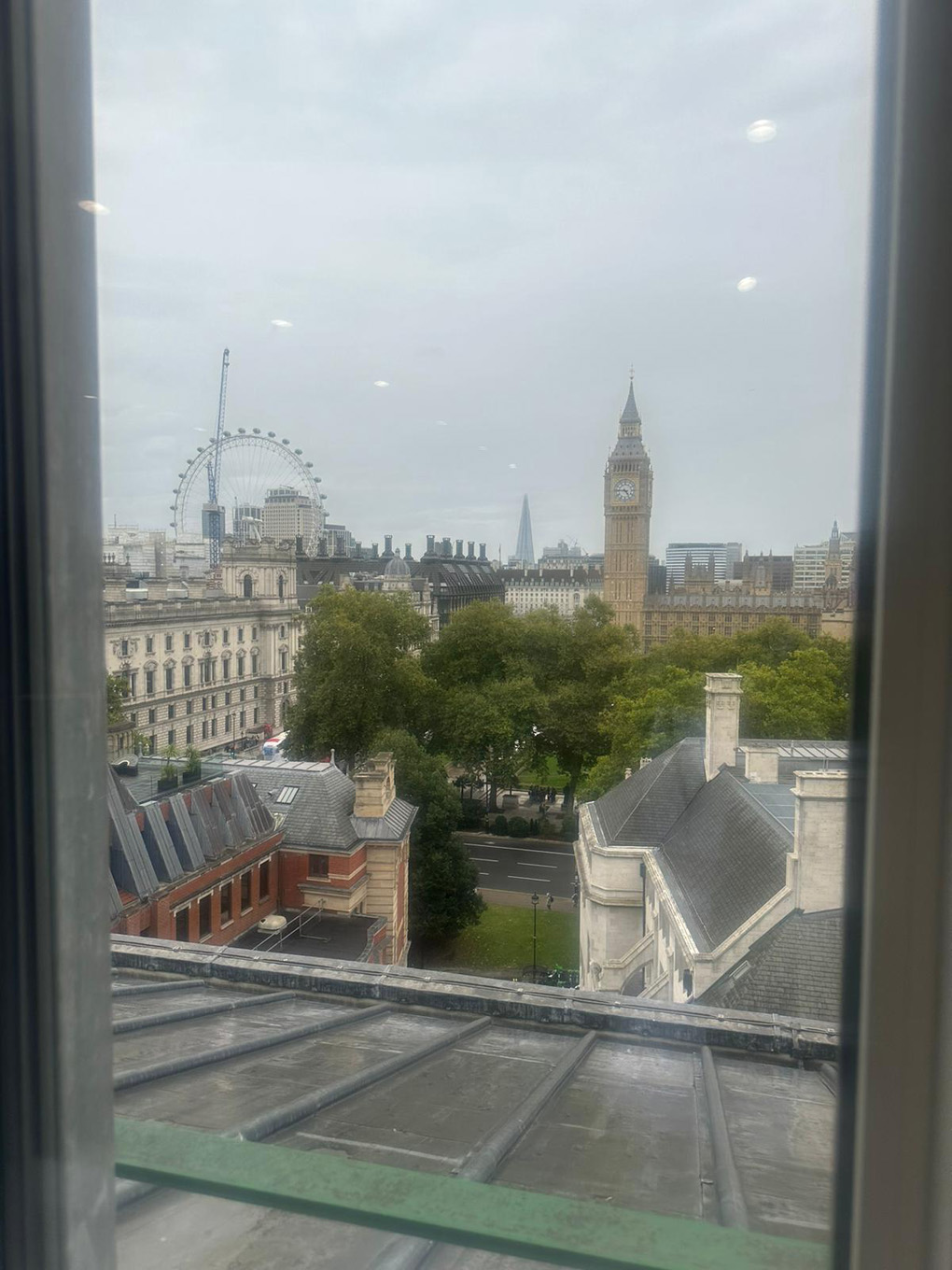 A view over the rooftops of London including the London Eye and Big Ben.