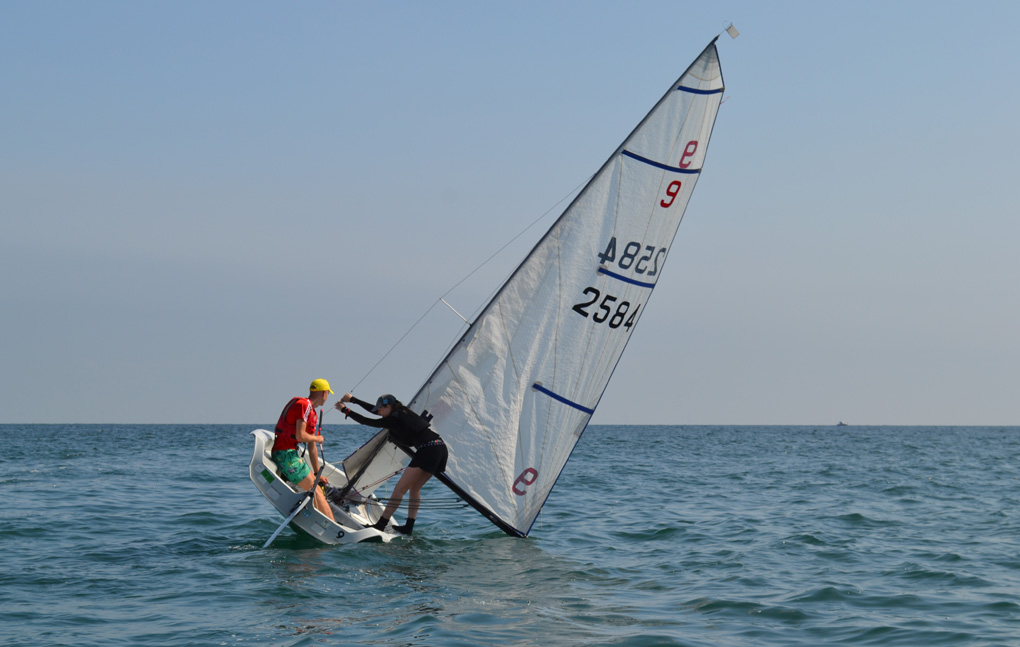 Sailing dinghy at rakeish angle