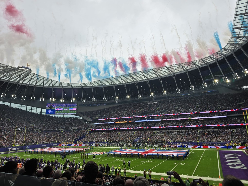 Flags out on an American Football field with fireworks before the game