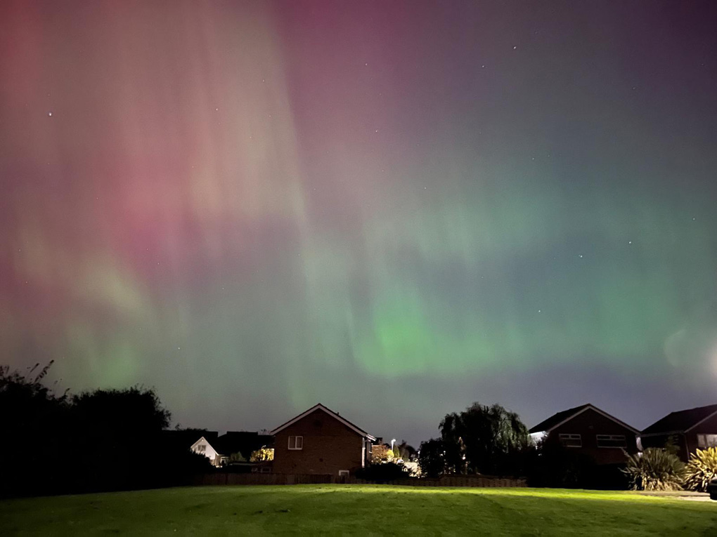 Aurora borealis over some houses