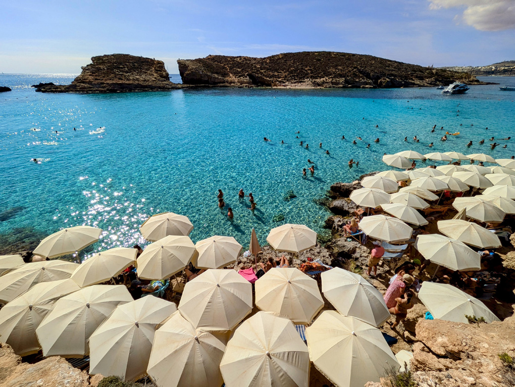 Blue lagoon and beach umbrellas on a sunny day.