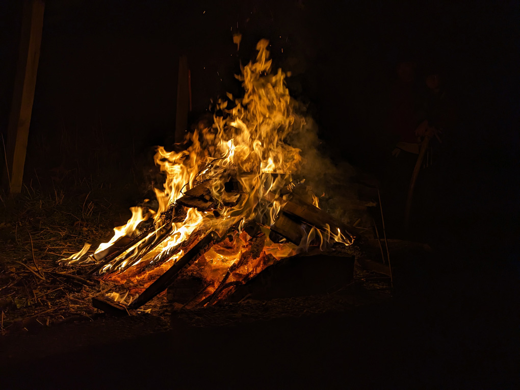 A small bonfire burning in the darkness