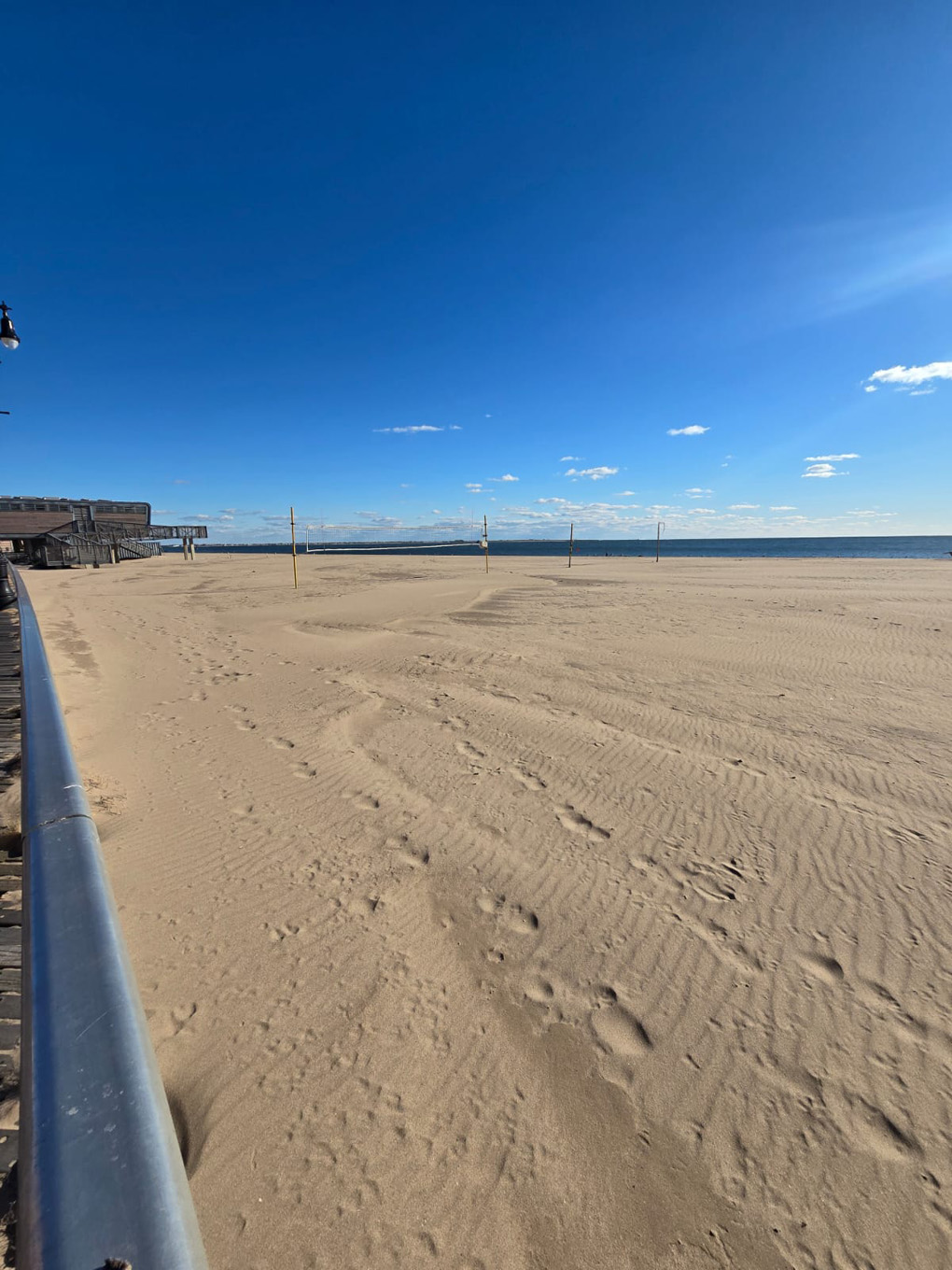 Wide empty beach with blue sky