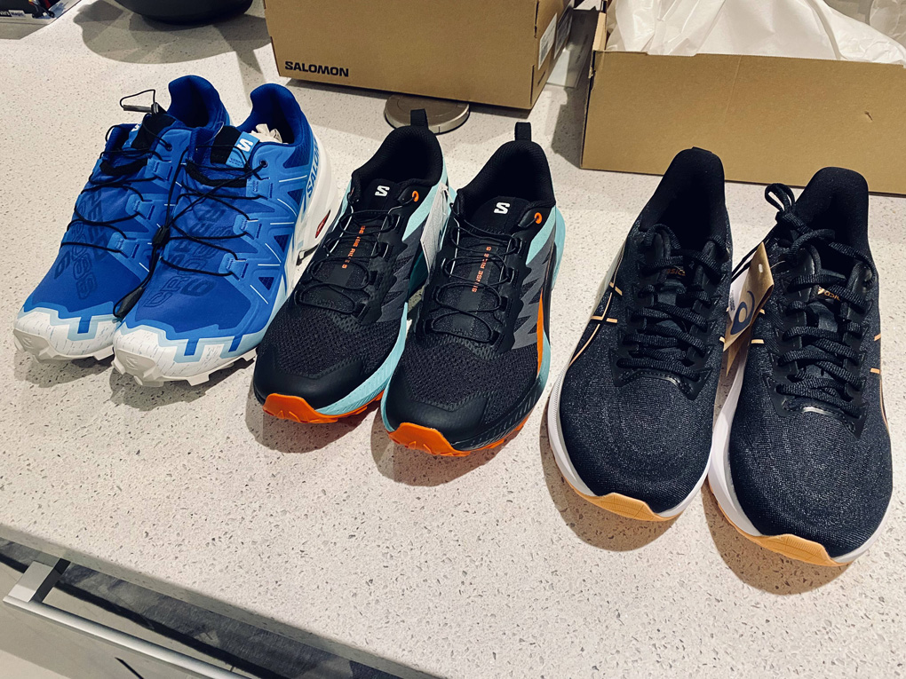 Three new pairs of running shoes lined up next to each other