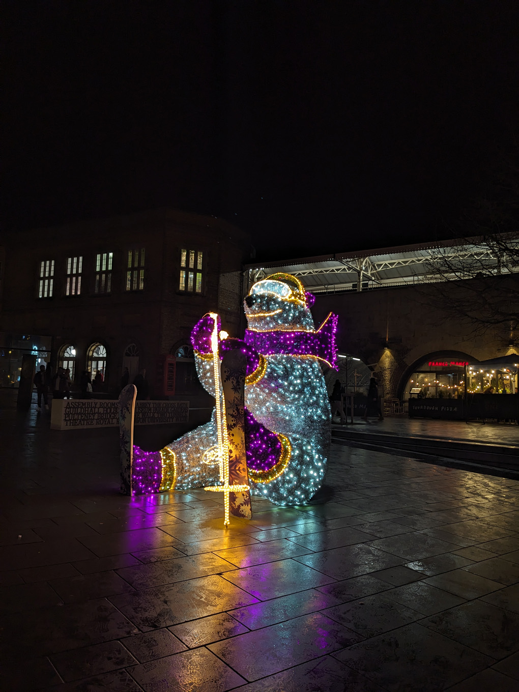 A giant polar bear in ski gear made out of lights