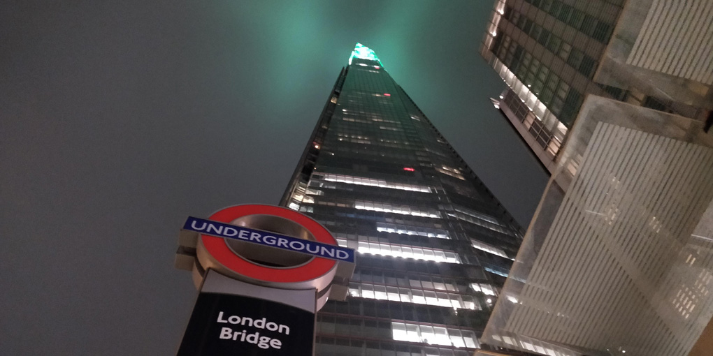 Looking up The Shard, from beneath the underground sign for London Bridge