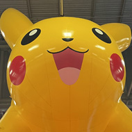 Inflatable giant Pikachu suspended over a conference venue