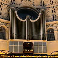 Image of the stage in the Oxford Town Hall covered by very convincing electric candles and the wonderful domed ceiling and huge pipe organ.