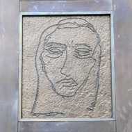 Doors by Tracey Emin featuring many faces sketched into bronze