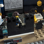 Lego model of a radio station in a clear box.
