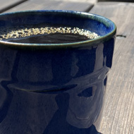 Coffee cup on a table outside.