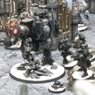 A table of warhammer 40,000 models face off against one another