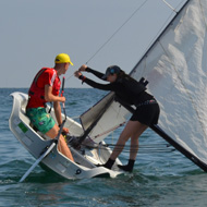 Sailing dinghy at rakeish angle