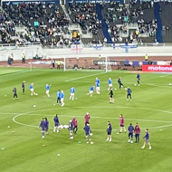 View from the stands to a football pitch in a stadium.