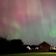 Aurora borealis over some houses