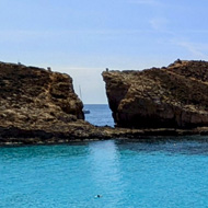 Blue lagoon and beach umbrellas on a sunny day.