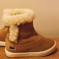 A pair of fur-lined, suede, light-brown baby boots.