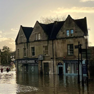 A flooded street with shop fronts under water