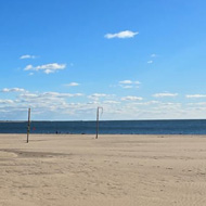 Wide empty beach with blue sky