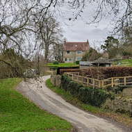 A winding road through Cotswold countryside