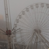 Buildings loom out of the fog