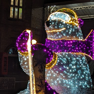 A giant polar bear in ski gear made out of lights