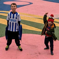 Two children standing by a caption 'Find Joy in the Small Things'