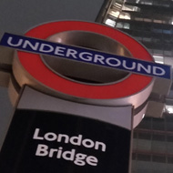 Looking up The Shard, from beneath the underground sign for London Bridge