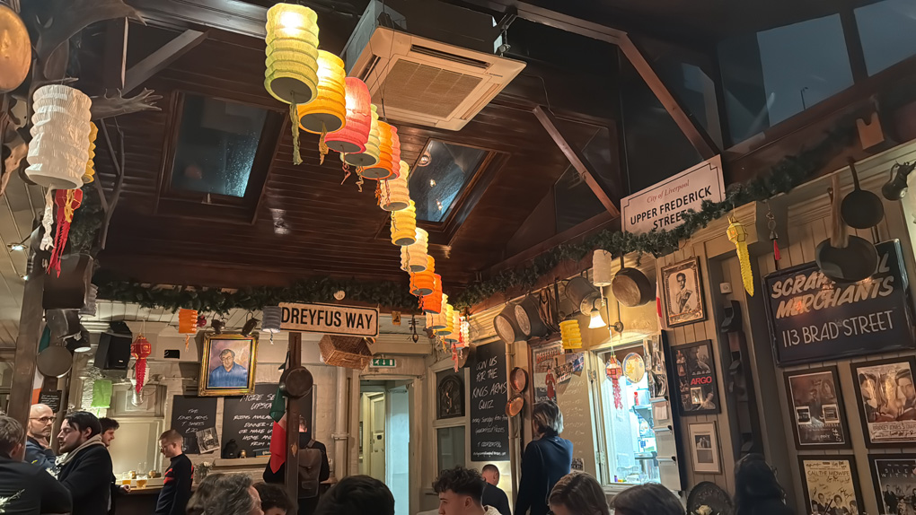 Pub decorated with ephemera lit with cosy lighting