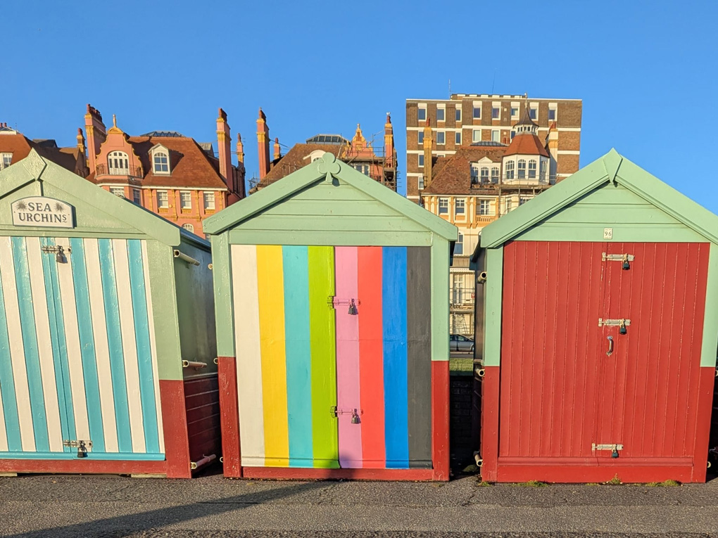 Multicoloured beach huts painted like the test card