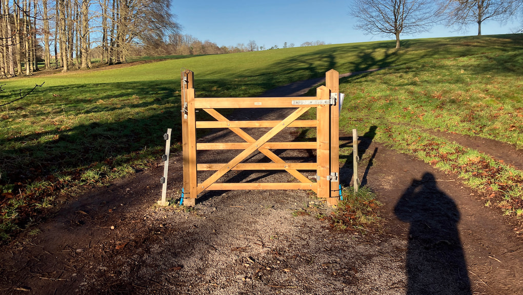 Photo of a gate in the middle of a path with no fencing either side so it's pretty pointless.