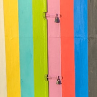 Multicoloured beach huts painted like the test card