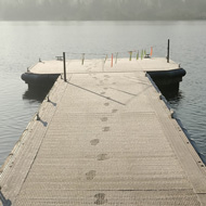 Sun rises over a frosty lake mooring pontoon